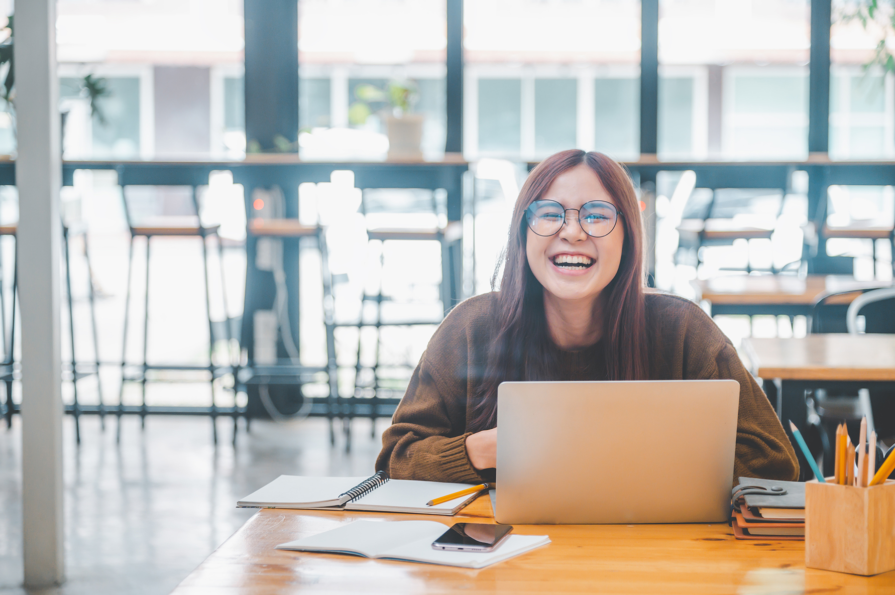 young student wearing headphones studies online, distance learni